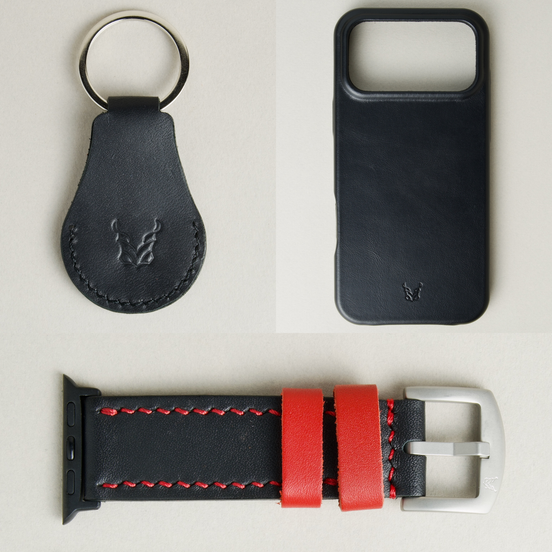 Three premium leather items for apple products: midnight black airtag keychain with metal key ring and embossed Markore logo, midnight black iphone 17 case with embossed Markore logo and midnight black and red watch strap with silver stainless steel buckle and black adapter.