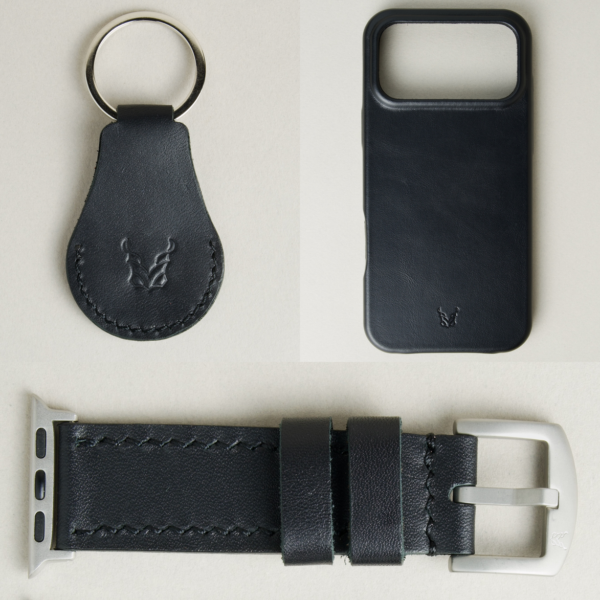 Three premium leather items for apple products in midnight black: airtag keychain with metal key ring and embossed Markore logo, iphone 17 case with embossed Markore logo and watch strap with silver stainless steel buckle and adapter.
