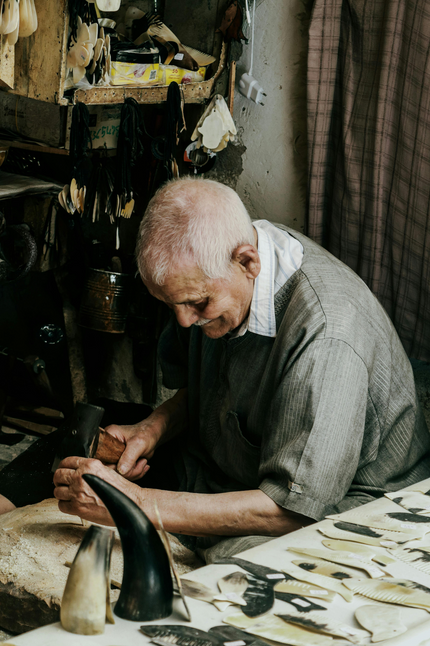 Artisan working with tools in a workshop setting