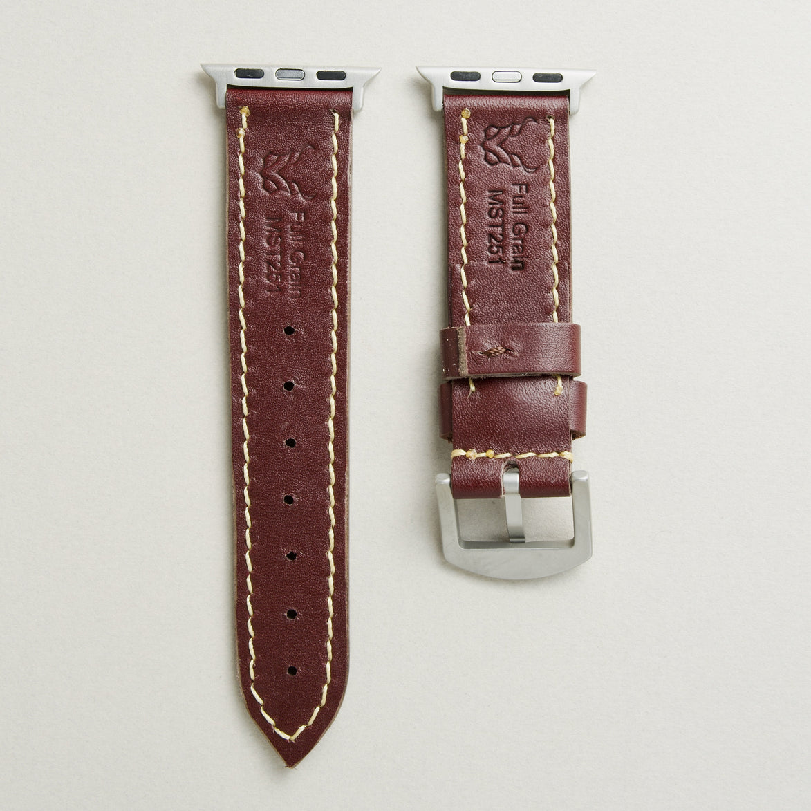 Back view of espresso brown leather strap with silver stainless steel adapters and buckle, showing handmade stitching, embossed logo, and serial number. Markore Hour Line.