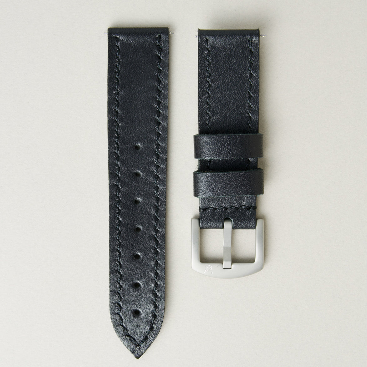 Midnight full-grain leather watch strap with handmade stitching, matching leather loops, and stainless steel buckle. Markore Hour Line.