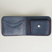 Inside view of full-grain leather bifold wallet with coin pocket and card slots, and hand-stitched red thread in Dark Blue Markore Hunza Arc.