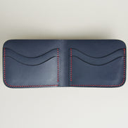 Inside view of full-grain leather bifold wallet with card slots and hand-stitched red thread in Dark Blue. Markore Hunza Arc.