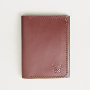 Front view of espresso brown full-grain leather flap fold wallet featuring a flap closure, handmade stitching and embossed logo. Markore Khaas Andaz.