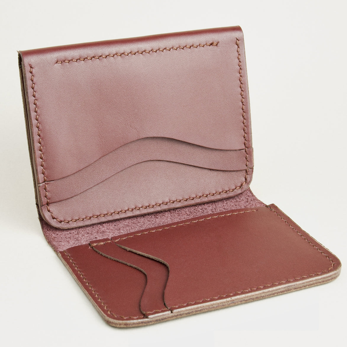 Inside view of espresso brown full-grain leather flap fold wallet featuring a flap closure, vertical and horizontal card slots and handmade stitching. Markore Khaas Andaz.