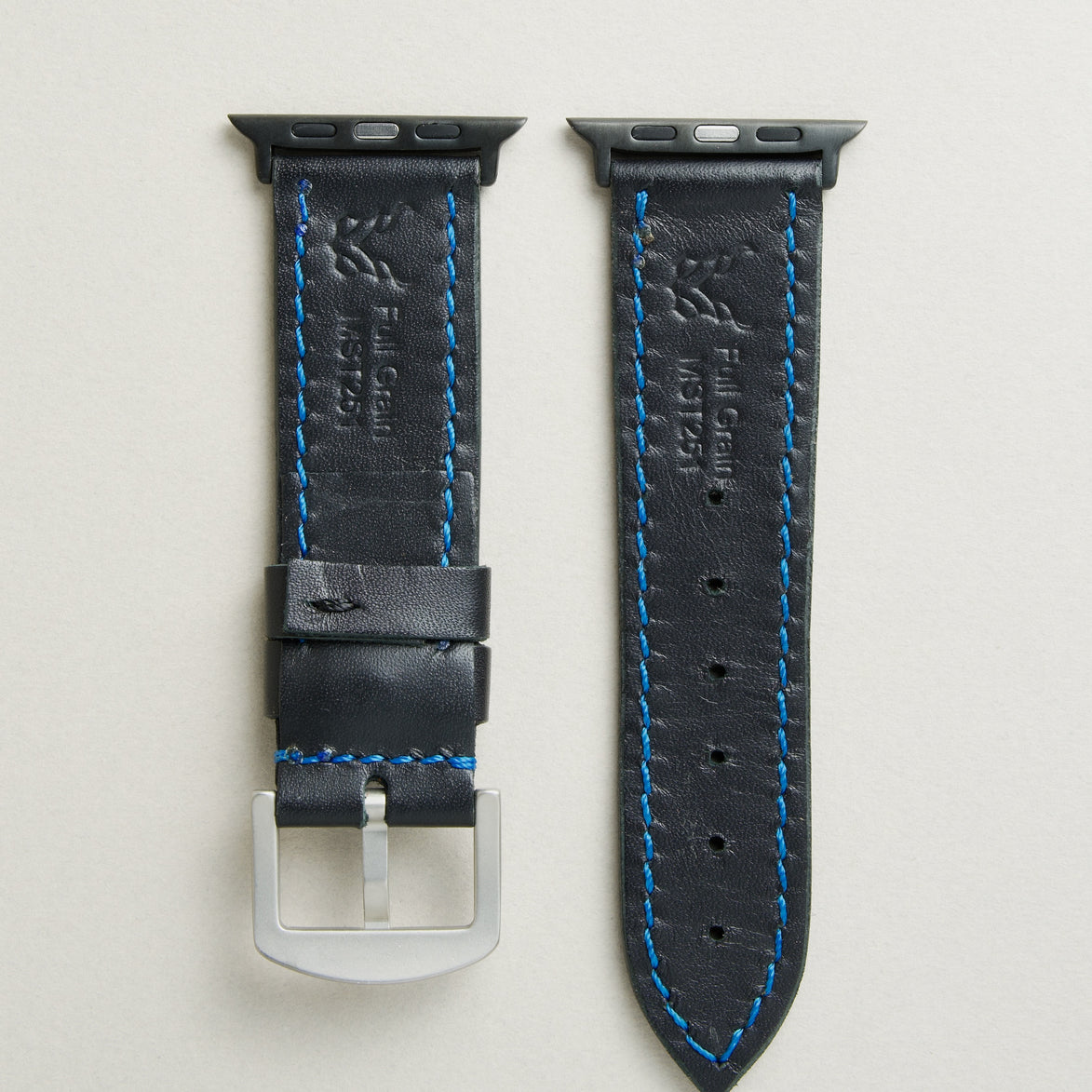 Back view of Midnight Black leather strap with black stainless steel adapters and silver buckle, showing blue stitching, embossed logo, and serial number. Markore Hour Line.