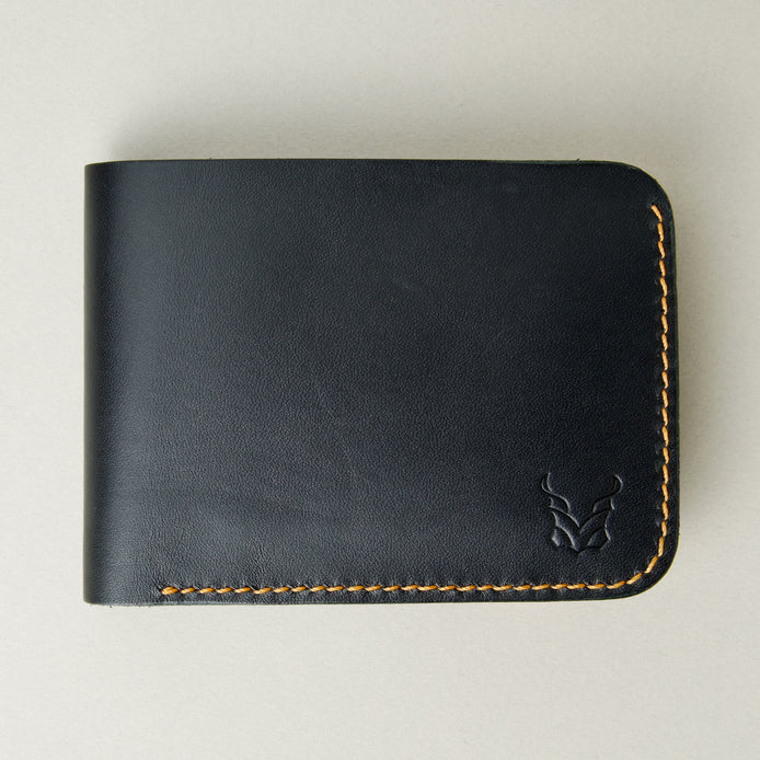 Front view of full grain leather bifold wallet in midnight black, featuring amber handmade stitching and embossed logo. Markore Hunza Fold.