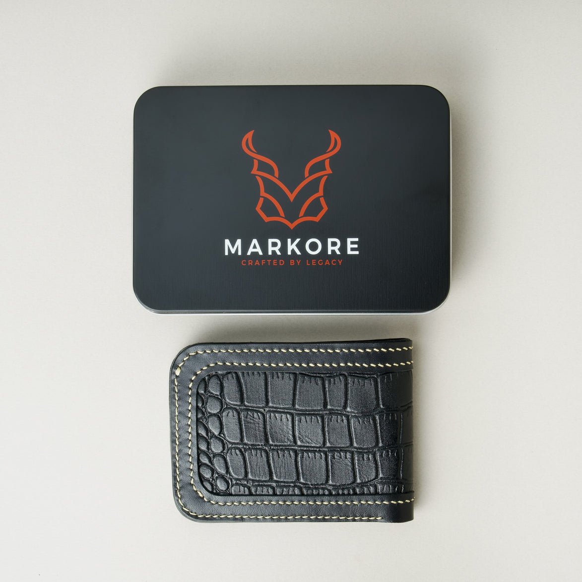 Back view of obsidian black croc-embossed full-grain leather bifold wallet featuring ivory handmade stitching and a black Markore branded box. Markore Indus Sultan