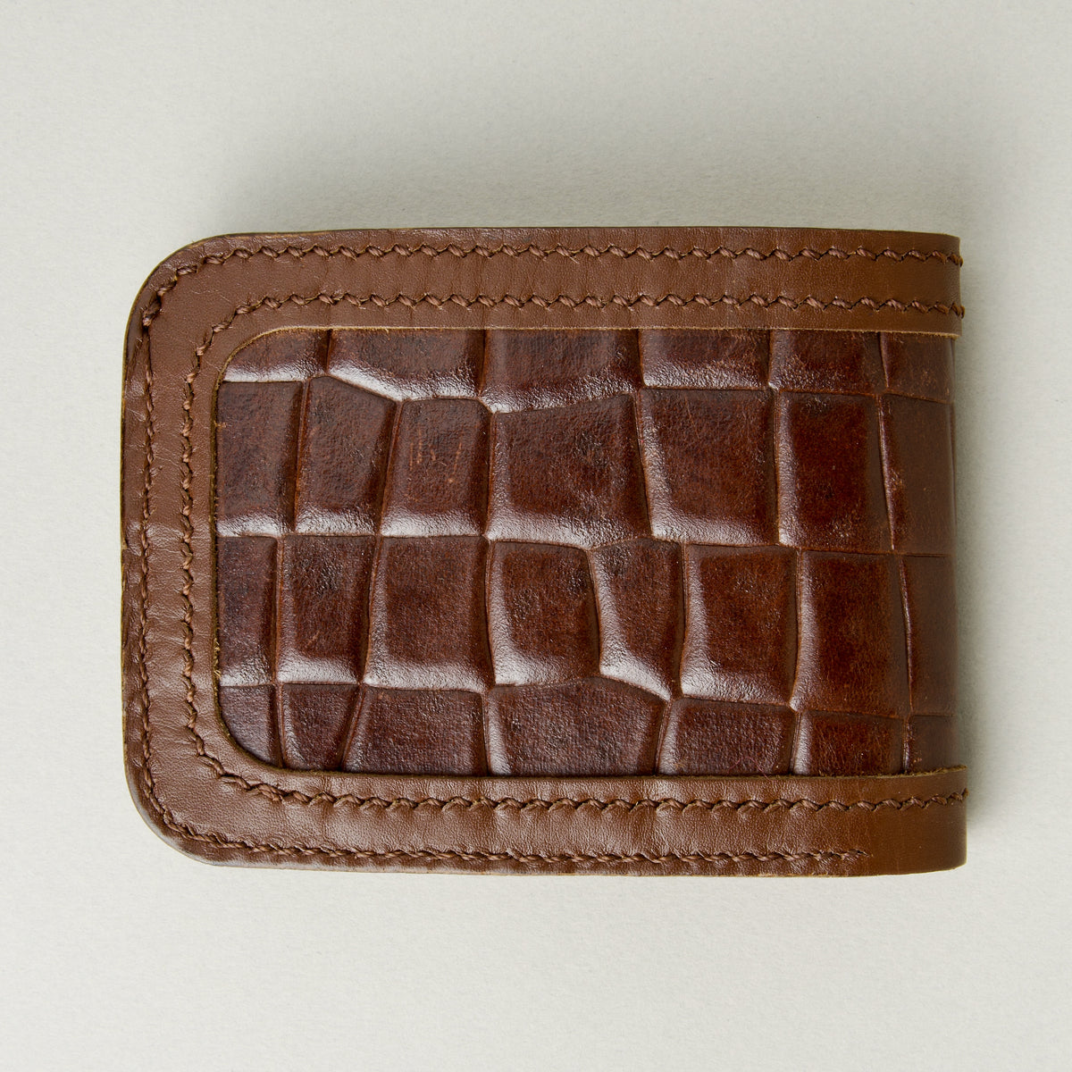 Back view of espresso brown croc-embossed full-grain leather bifold wallet featuring handmade stitching. Markore Indus Sultan