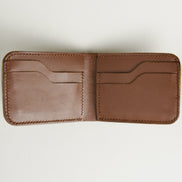 Interior view of espresso brown full-grain leather bifold wallet featuring handmade stitching and card slots. Markore Indus Sultan