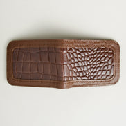 Outside view of espresso brown croc-embossed full-grain leather bifold wallet featuring handmade stitching. Markore Indus Sultan