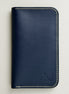 front view of vertical full-grain leather bifold wallet in dark blue, featuring handmade stitching in ivory and embossed logo. Markore Karakoram II.