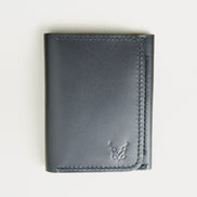 Front view of midnight black full-grain leather flap fold wallet featuring a flap closure, handmade stitching and embossed logo. Markore Khaas Andaz.