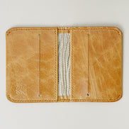 Inside view of leather bifold wallet in natural, featuring handmade stitching, card slots and RFID-blocking lining. Markore Natural.