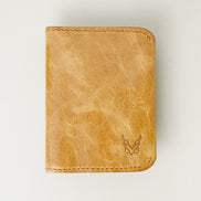 Front view of leather bifold wallet in natural, featuring handmade stitching and embossed logo. Markore Natural.
