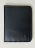 Front view of midnight black full-grain leather wallet featuring espresso brown handmade stitching and embossed logo. Markore Ravi Fold.