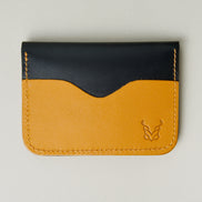 Front view of midnight black full-grain leather wallet featuring amber card slot, amber handmade stitching and embossed logo. Markore Ravi Slip.