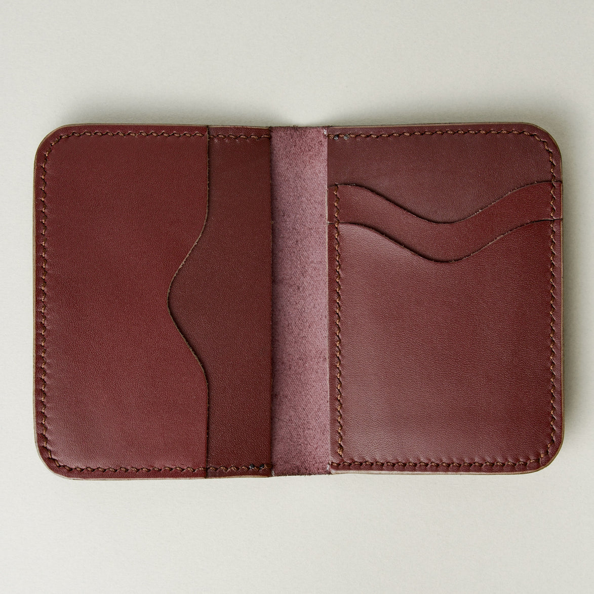Interior view of espresso brown full-grain leather wallet featuring card slots and handmade stitching. Markore Ravi Slip.