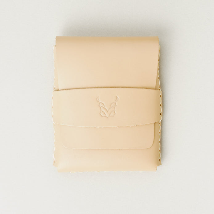 Front view of natural full-grain leather flap wallet featuring a flap holder with embossed logo, and handmade stitching. Markore Sutlej Vault.