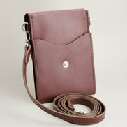 Inside view of vertical full-grain leather crossbody bag and matching shoulder strap in Espresso Brown, showing handmade stitching and stainless steel press stud. Markore Nora Veldt.