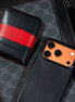 Markore Sutlej Vault and Markore Shell Frame iphone 17 pro case in midnight black lying on canvas bag.